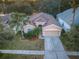 Aerial view of charming house with two-car garage and palm trees at 19144 Meadow Pine Dr, Tampa, FL 33647