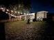 Fenced backyard with string lights at night at 19144 Meadow Pine Dr, Tampa, FL 33647