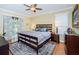 Large main bedroom with king-size bed and sliding glass doors at 19144 Meadow Pine Dr, Tampa, FL 33647