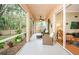 Relaxing screened porch with wicker furniture and ceiling fan at 19144 Meadow Pine Dr, Tampa, FL 33647