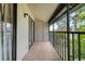 Screened balcony with tiled flooring and exterior access at 2375 Lake Heather Heights Ct # 202, Dunedin, FL 34698