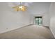 Bright bedroom with carpeted floors and sliding glass doors at 2375 Lake Heather Heights Ct # 202, Dunedin, FL 34698