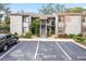 Condo building with parking lot and landscaping in front at 2375 Lake Heather Heights Ct # 202, Dunedin, FL 34698