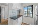 White kitchen cabinets and granite countertops at 2375 Lake Heather Heights Ct # 202, Dunedin, FL 34698