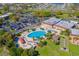 Aerial view of community pool, clubhouse, and parking at 2431 Kensington Greens Dr # 0, Sun City Center, FL 33573