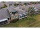 Aerial view showcasing home's rear, highlighting the sunroom and landscape at 2431 Kensington Greens Dr # 0, Sun City Center, FL 33573