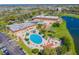 Aerial view of community pool, clubhouse, and parking at 2431 Kensington Greens Dr # 0, Sun City Center, FL 33573