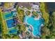 Aerial view of community pool, tennis courts, and clubhouse at 2431 Kensington Greens Dr # 0, Sun City Center, FL 33573