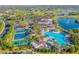 Aerial view of community pool, clubhouse, and pickleball courts at 2431 Kensington Greens Dr # 0, Sun City Center, FL 33573