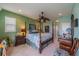 Main bedroom with a four poster bed, and ample natural light at 2431 Kensington Greens Dr # 0, Sun City Center, FL 33573