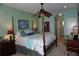 Spacious Primary bedroom with a post bed and en-suite bathroom at 2431 Kensington Greens Dr # 0, Sun City Center, FL 33573