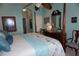 Primary bedroom with a post bed, dresser and golf course view at 2431 Kensington Greens Dr # 0, Sun City Center, FL 33573