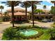 Community clubhouse with fountain and palm trees at 2431 Kensington Greens Dr # 0, Sun City Center, FL 33573