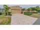 Tan two-story house with a three-car garage and paved driveway at 2431 Kensington Greens Dr # 0, Sun City Center, FL 33573