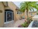 Inviting front patio with seating area and colorful landscaping at 2431 Kensington Greens Dr # 0, Sun City Center, FL 33573