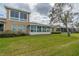 Back exterior of house with sunroom and landscaping at 2431 Kensington Greens Dr # 0, Sun City Center, FL 33573