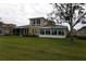 Tan two-story house with large windows, screened porch, and sunroom at 2431 Kensington Greens Dr # 0, Sun City Center, FL 33573