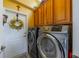 Well-equipped laundry room with washer, dryer, and ample cabinetry at 2431 Kensington Greens Dr # 0, Sun City Center, FL 33573