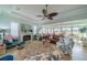 Relaxing living room with fireplace, ceiling fan, and access to a sunroom at 2431 Kensington Greens Dr # 0, Sun City Center, FL 33573