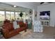 Living area with sunroom access and view of golf course at 2431 Kensington Greens Dr # 0, Sun City Center, FL 33573