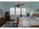 Main bedroom with wood floors, ceiling fan, and large windows at 2431 Kensington Greens Dr # 0, Sun City Center, FL 33573