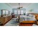 Large main bedroom with king-size bed, dresser, and ceiling fan at 2431 Kensington Greens Dr # 0, Sun City Center, FL 33573