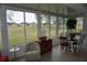 Sunroom with golf course view and comfortable seating at 2431 Kensington Greens Dr # 0, Sun City Center, FL 33573