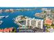 Aerial view of waterfront property, showing building, pool, and marina at 255 Dolphin Pt Pt # 603, Clearwater Beach, FL 33767