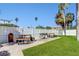 Outdoor BBQ area with picnic tables and lush green lawn at 255 Dolphin Pt Pt # 603, Clearwater Beach, FL 33767