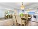 Dining area with glass top table and four chairs, mirrored wall and hardwood floor at 255 Dolphin Pt Pt # 603, Clearwater Beach, FL 33767