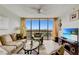 Living room boasts large window, city view, comfy seating, and hardwood floors at 255 Dolphin Pt Pt # 603, Clearwater Beach, FL 33767