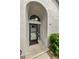 Close-up of the front door entryway with modern door and light fixture at 2749 Countryside Blvd # 18, Clearwater, FL 33761