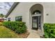 Modern front door with arched entryway and well-manicured landscaping at 2749 Countryside Blvd # 18, Clearwater, FL 33761