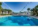 Inviting community pool with lounge chairs and shaded seating areas at 2749 Countryside Blvd # 18, Clearwater, FL 33761