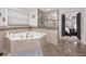 Elegant bathroom featuring a corner jacuzzi tub and a separate shower at 2893 Allapattah Dr, Clearwater, FL 33761