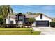 Two-story house with a dark gray garage door and a well-manicured lawn at 2893 Allapattah Dr, Clearwater, FL 33761