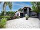 Modern home with a paved courtyard and lush landscaping at 2893 Allapattah Dr, Clearwater, FL 33761