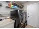 Laundry room with washer, dryer, and ample shelving at 2893 Allapattah Dr, Clearwater, FL 33761