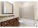 Bathroom with granite countertop vanity and tub shower combo at 29149 Cochiti Lake Dr, San Antonio, FL 33576