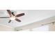 Modern ceiling fan with wood blades and light fixture at 29149 Cochiti Lake Dr, San Antonio, FL 33576