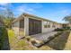 Home exterior showcasing a screened patio and landscaping at 29149 Cochiti Lake Dr, San Antonio, FL 33576