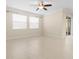 Living room with tile floors, neutral walls, and sliding glass doors at 29149 Cochiti Lake Dr, San Antonio, FL 33576