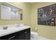 Modern bathroom with dark vanity & statement art at 301 1St S St # 3204, St Petersburg, FL 33701