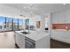 Modern kitchen with island, white cabinets and city views at 301 1St S St # 3204, St Petersburg, FL 33701