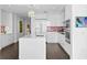 Modern white kitchen with a large island and pink tile backsplash at 301 1St S St # 3204, St Petersburg, FL 33701