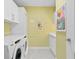 Modern laundry room with white cabinets & washer/dryer at 301 1St S St # 3204, St Petersburg, FL 33701