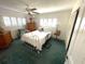 Bedroom with double bed, ceiling fan and dresser at 3182 65Th N St, St Petersburg, FL 33710