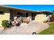 Inviting front porch with wicker furniture and brick pavers at 3182 65Th N St, St Petersburg, FL 33710