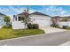 Two-car garage with driveway and landscaping at 3809 Lajuana Blvd, Wesley Chapel, FL 33543