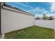 Grass side yard with white vinyl fence at 3809 Lajuana Blvd, Wesley Chapel, FL 33543